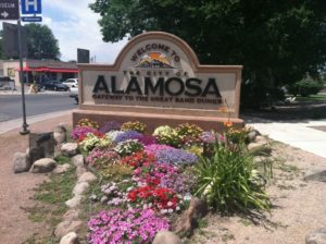Some of Alamosa's gardeners planted a greeting at the entry to the town.