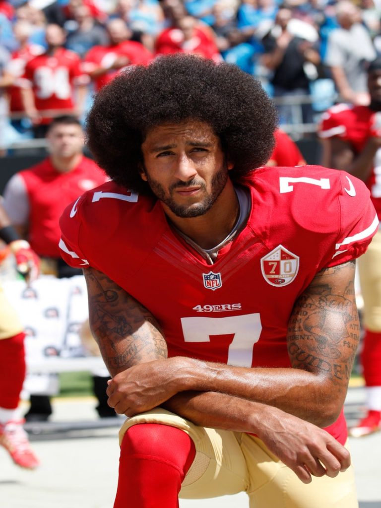Colin Rand Kaepernick takes a knee during a National Football League game.